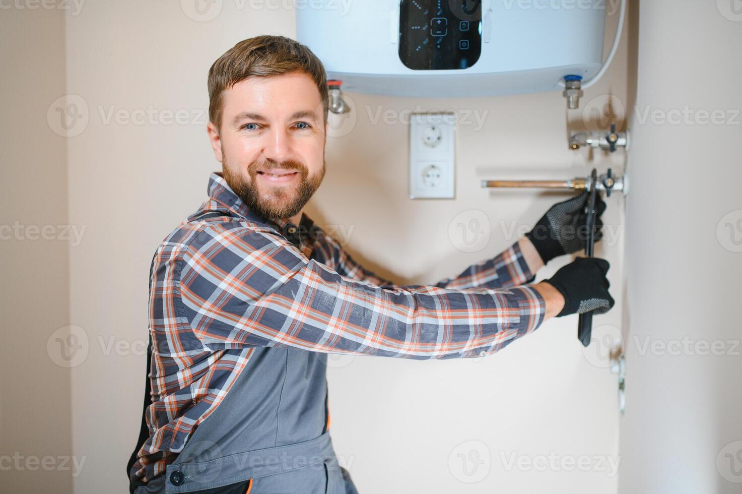 Professional plumber checking a boiler and pipes, boiler service concept photo