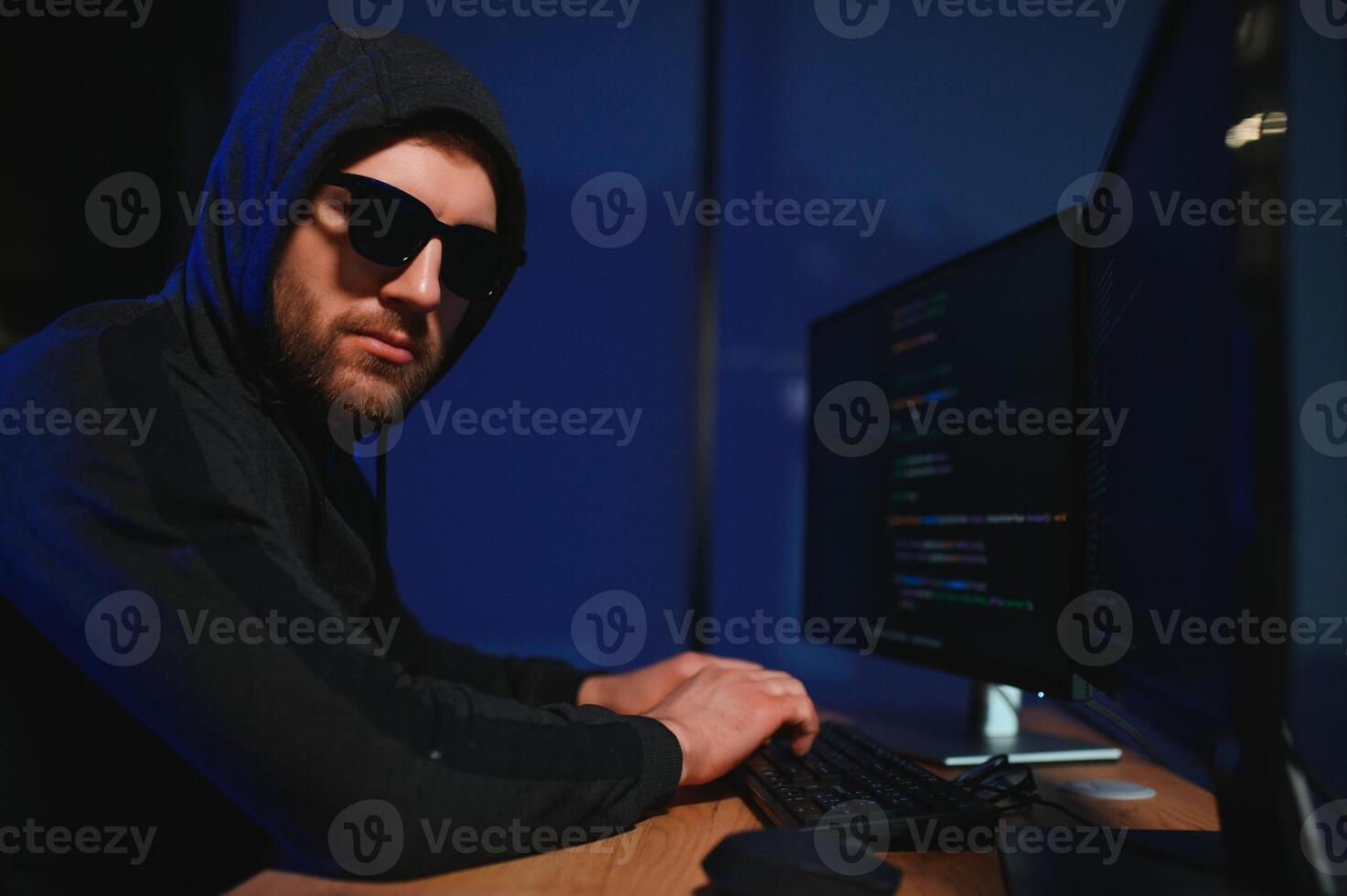 Wanted hackers coding virus ransomware using laptops and computers. Cyber attack, system breaking and malware concept photo