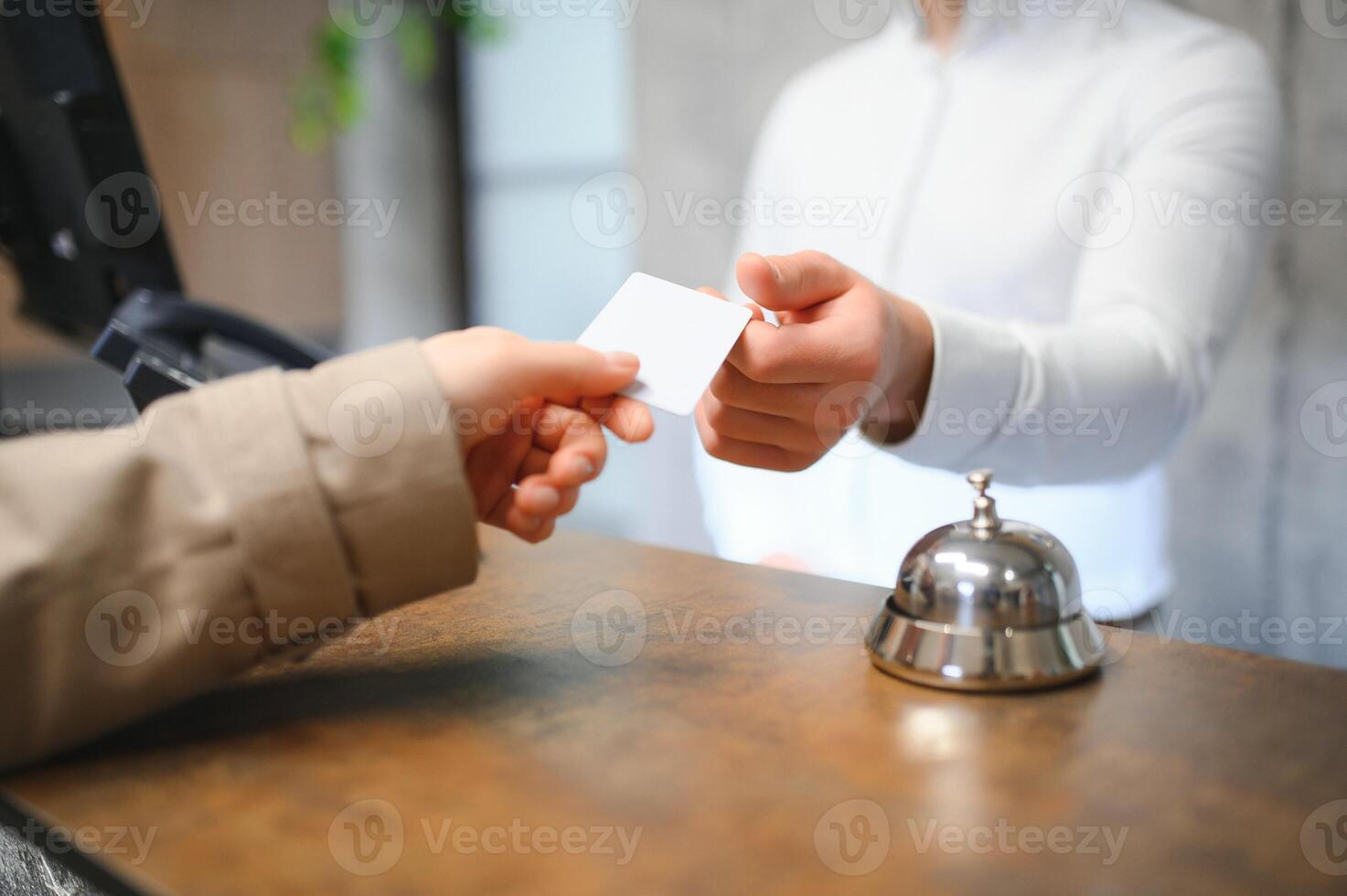 Picture of guests getting key card in hotel photo