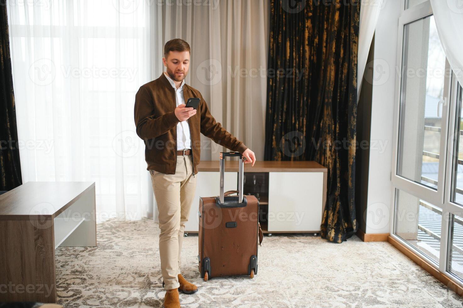 Mature businessman in a hotel room photo