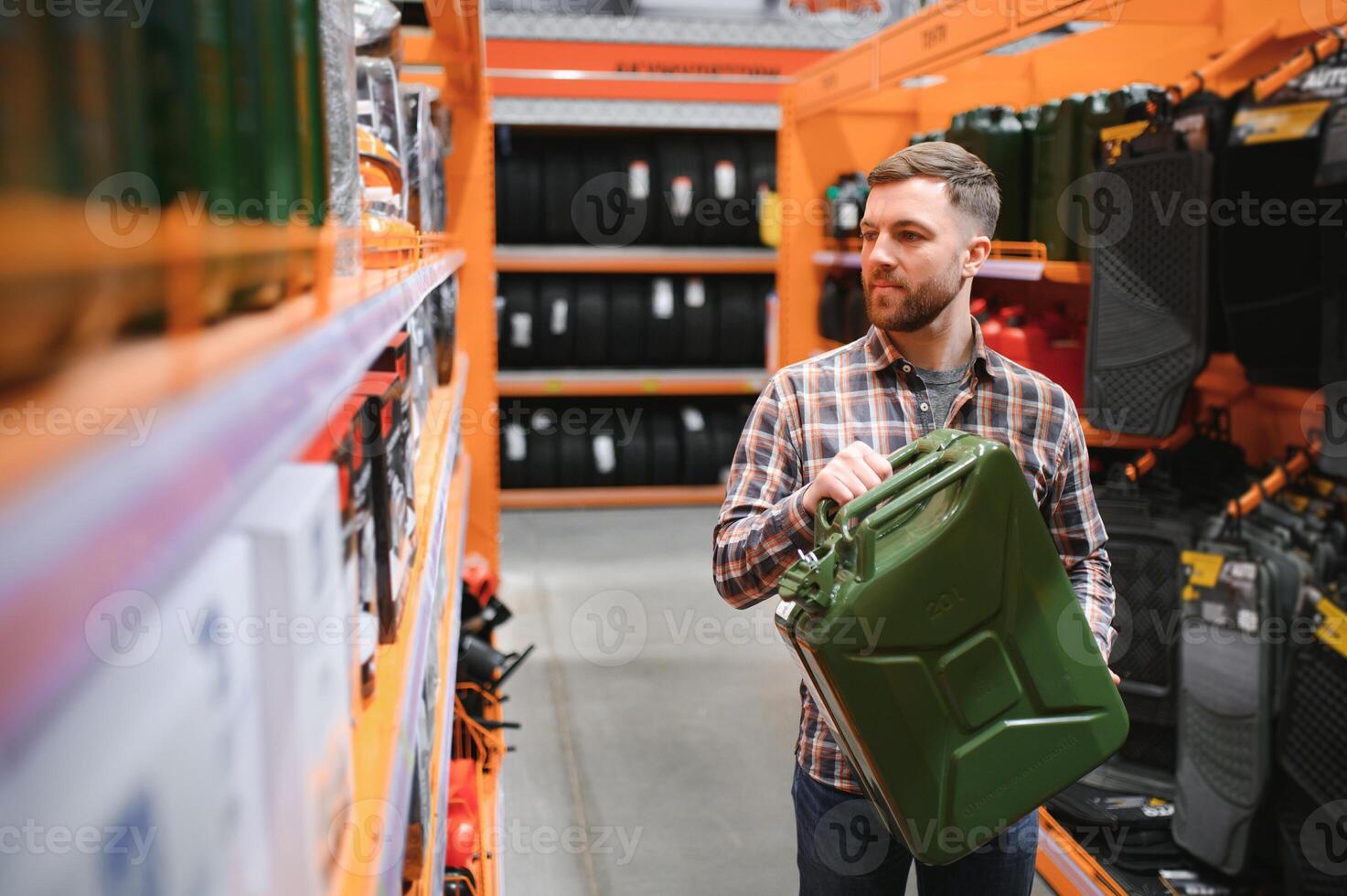 A male customer stands in an auto parts store with a jerry can photo