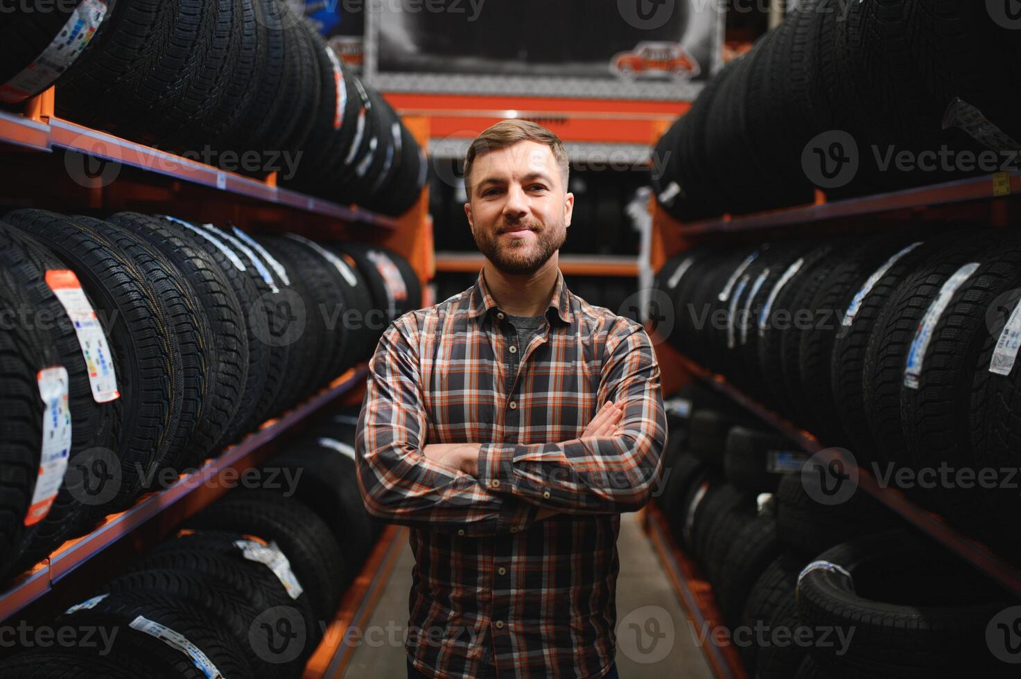 Man chooses winter car tires in the auto shop photo