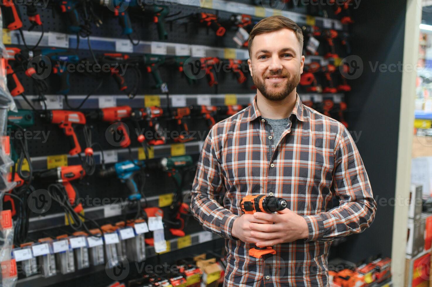 Portrait of happy mature man standing in hardware store photo