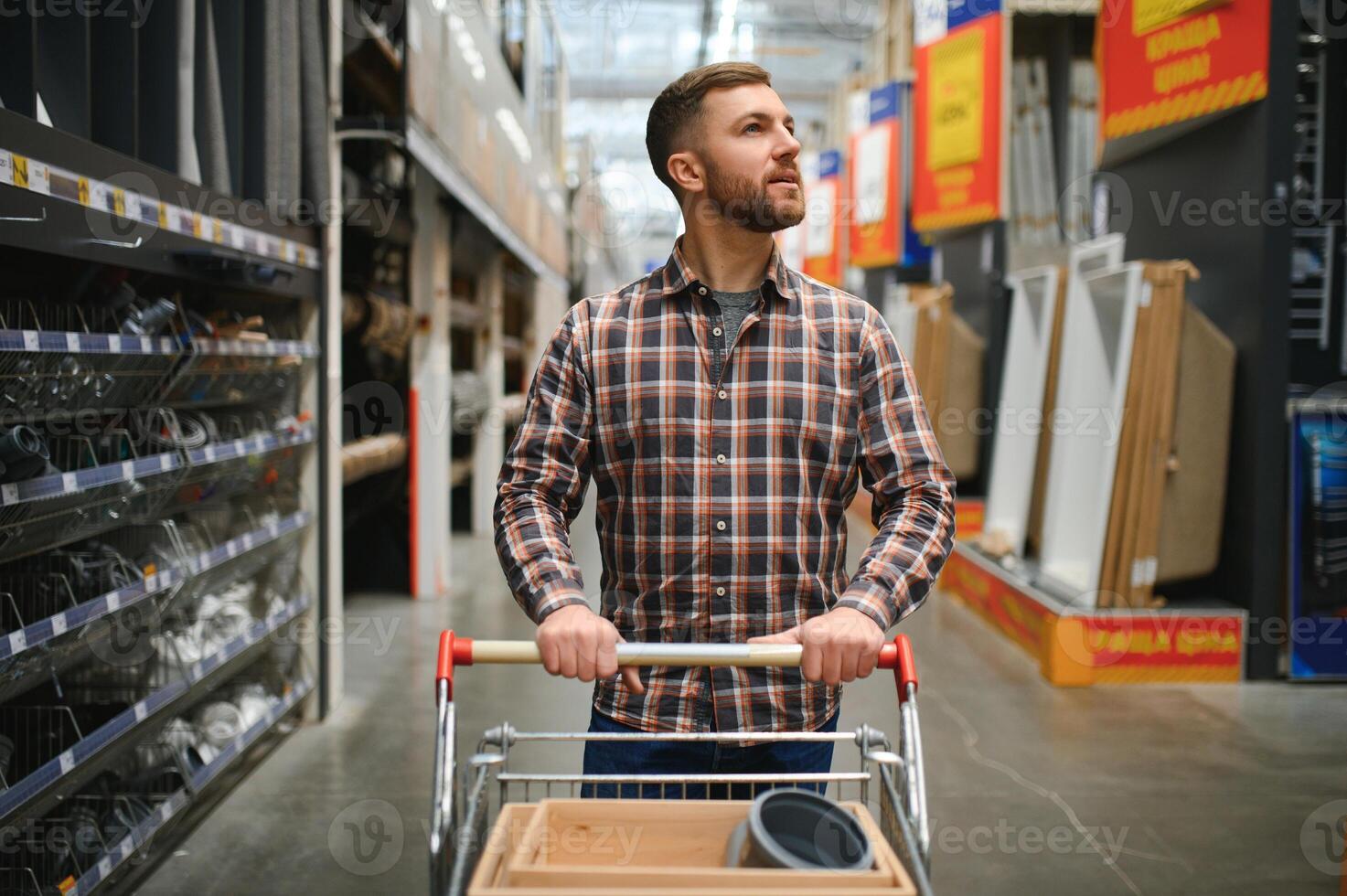 Portrait of happy mature man standing in hardware store photo