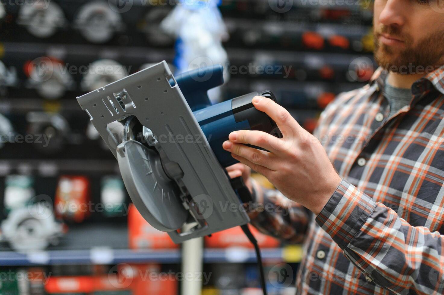 handsome young man shopping for tools at hardware store photo