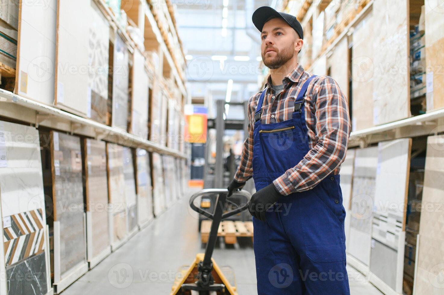 a worker in a hardware store stands in a warehouse photo