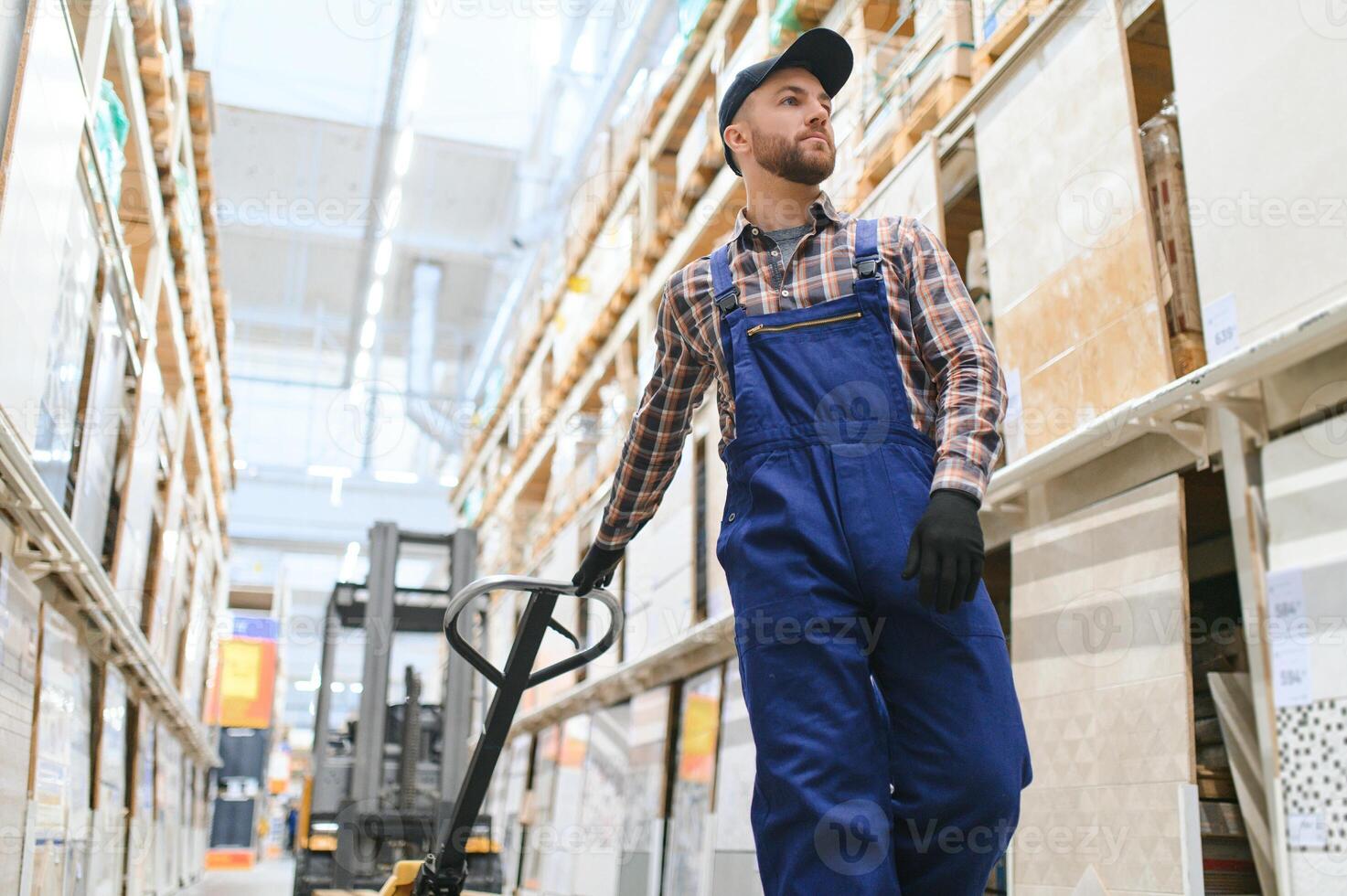 a worker in a hardware store stands in a warehouse photo