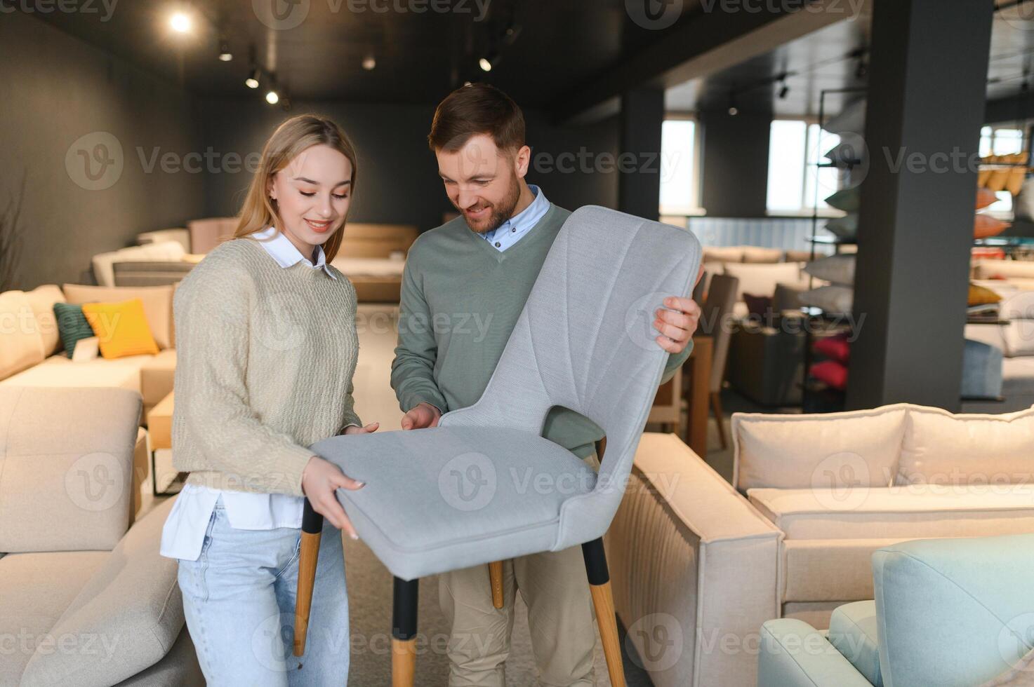 Happy couple choosing furniture in store photo