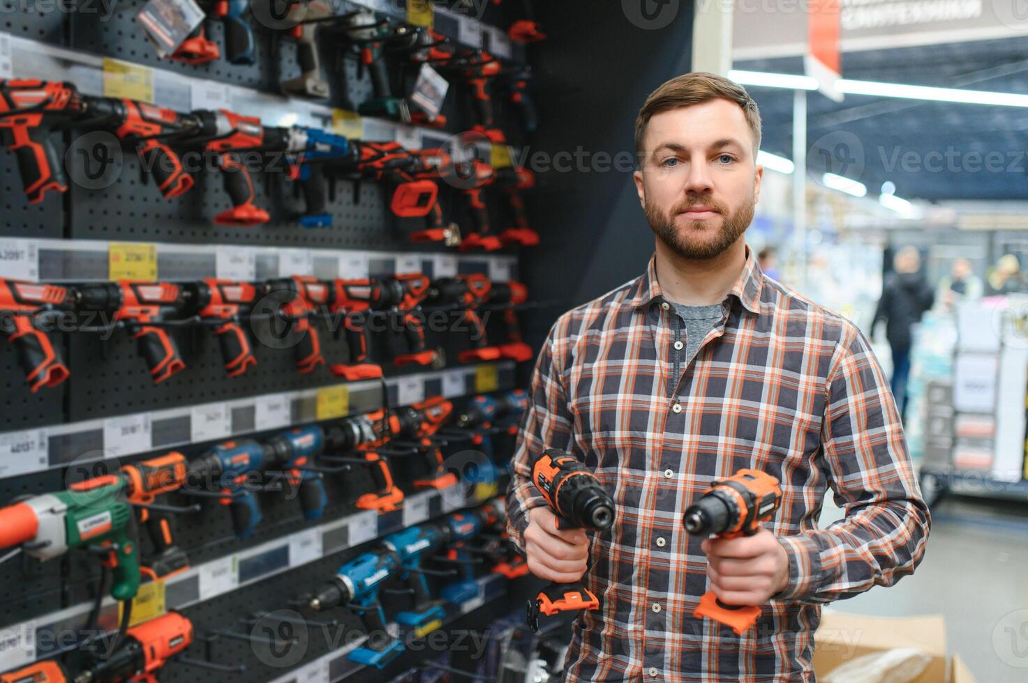 Man shopping for drill in hardware store photo