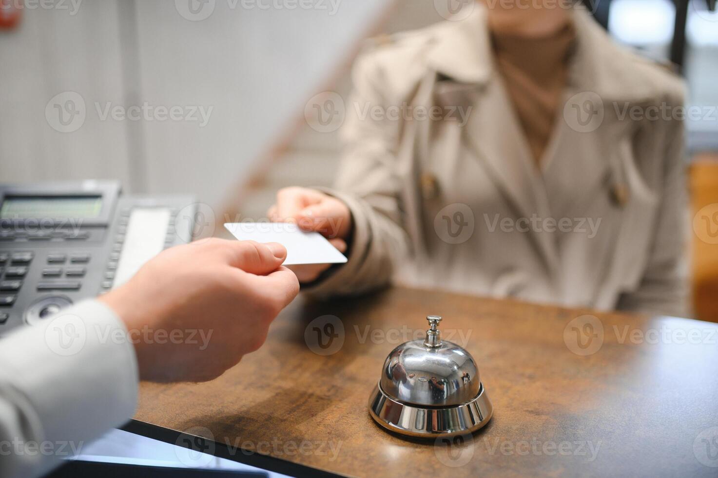 Close up of hand guest takes room key at check-in desk of the hotel. Hotel concept photo