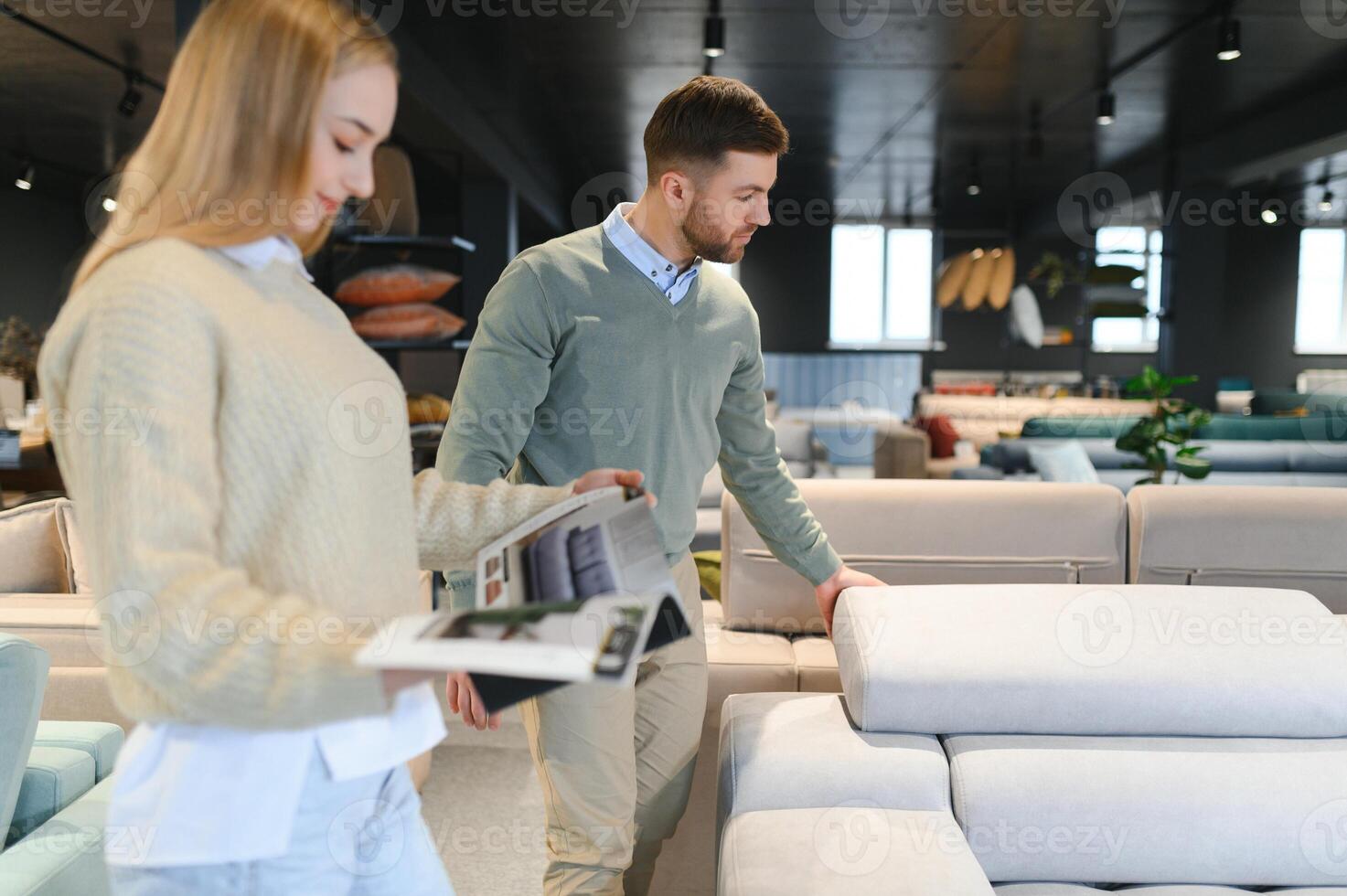 Attractive woman with her husband at the furniture store showroom photo