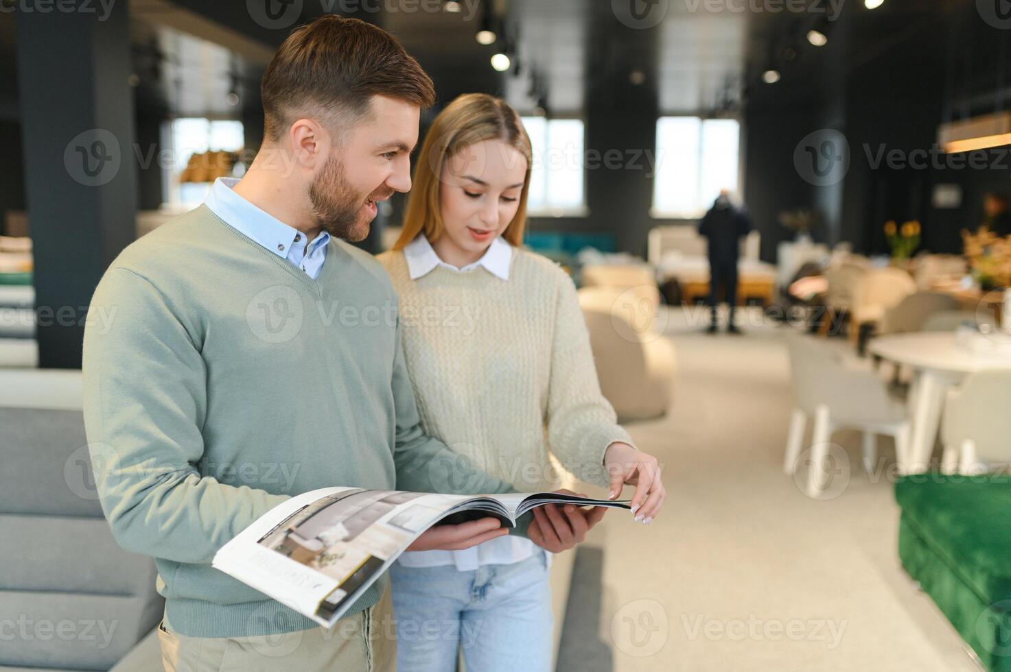 Couple choosing sofa in furniture store photo