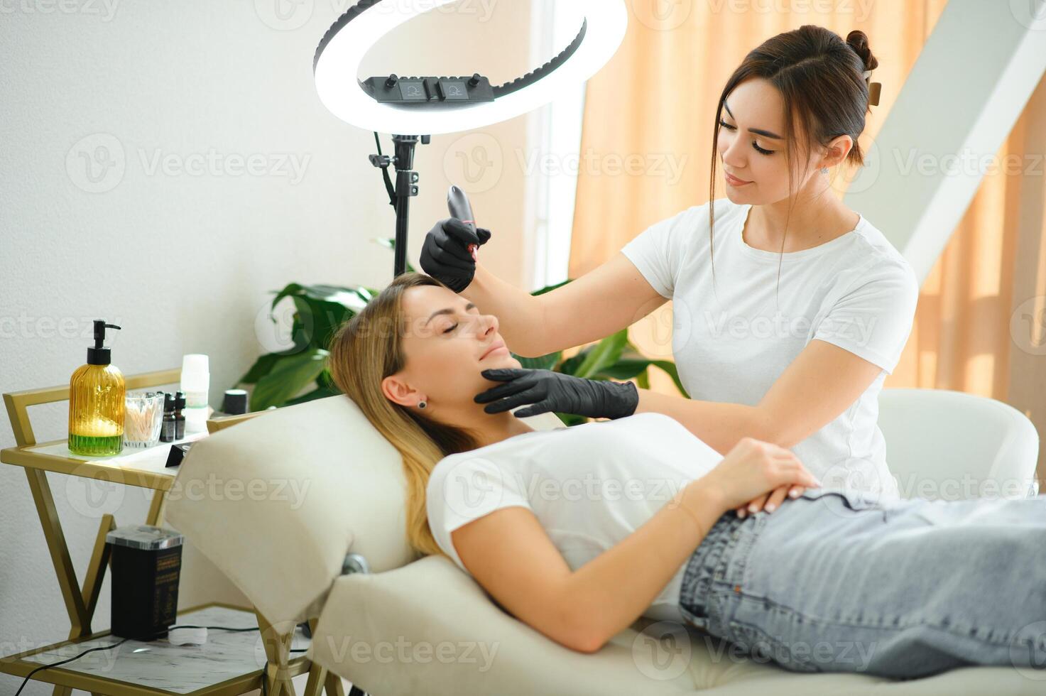 Eyebrows tattoo or Permanent Makeup. Beauty eyebrow upgrade procedure. photo
