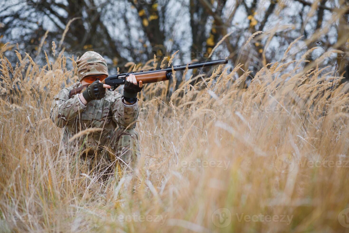 Hunter in uniform with a hunting rifle. Hunting Concept. photo