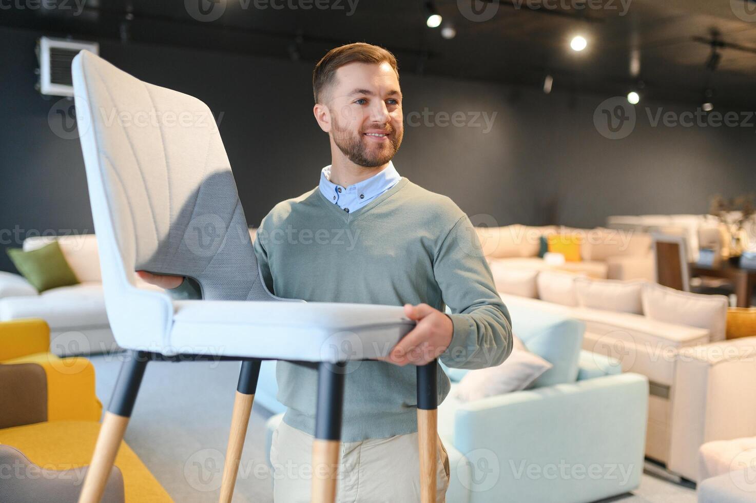 Front view of customer choosing chair in furniture store. photo