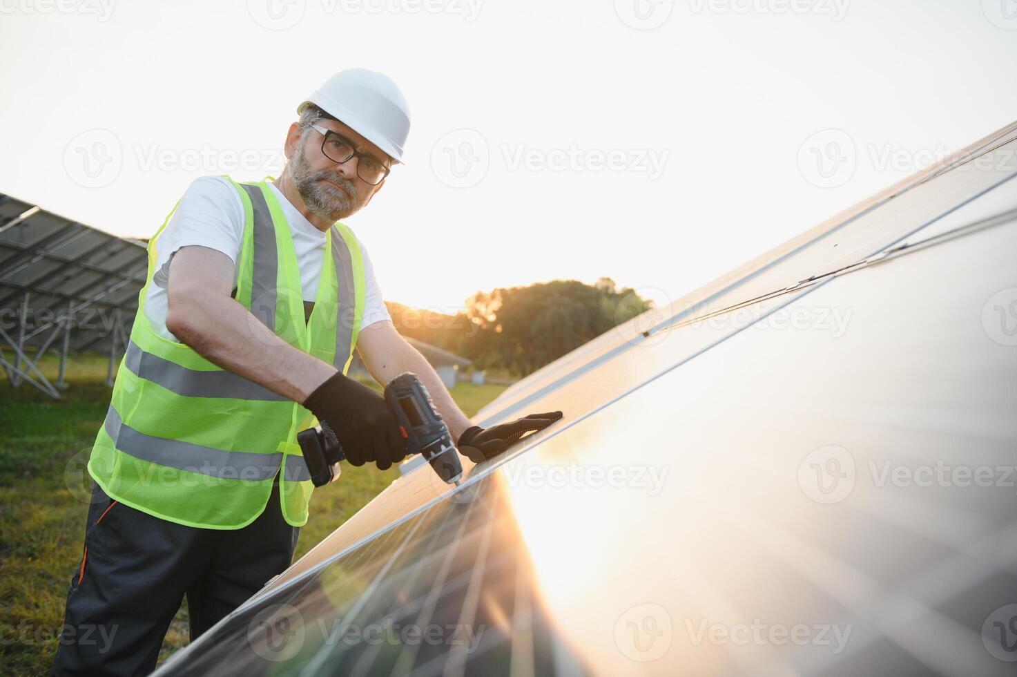 Worker installing solar panels outdoors photo