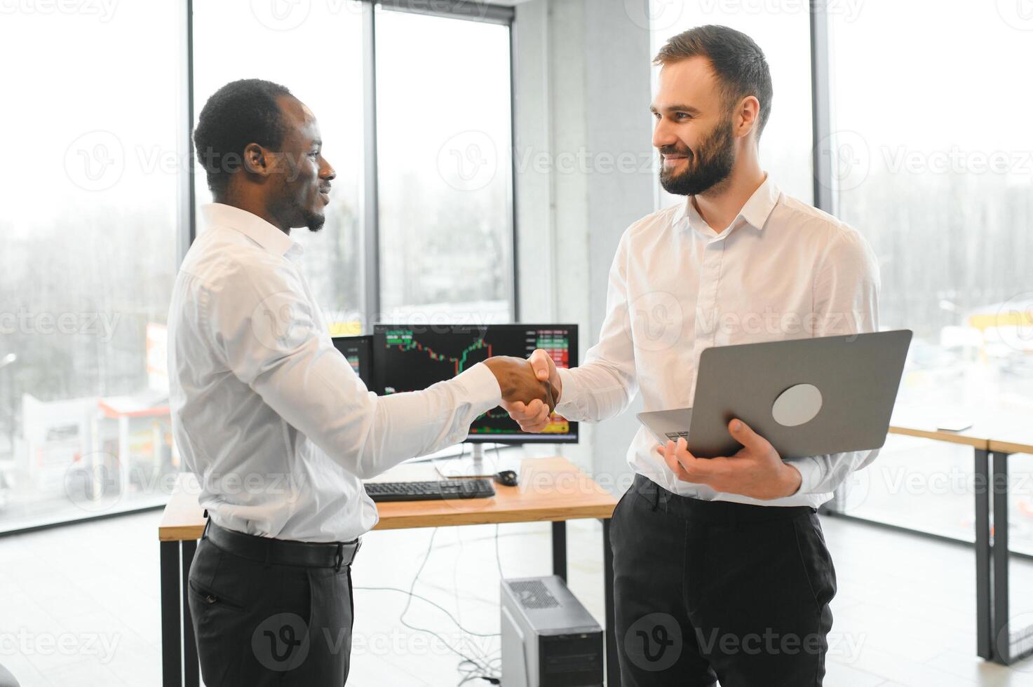 Two happy successful excited diverse traders investors giving high five celebrating successful stock exchange trading deal photo