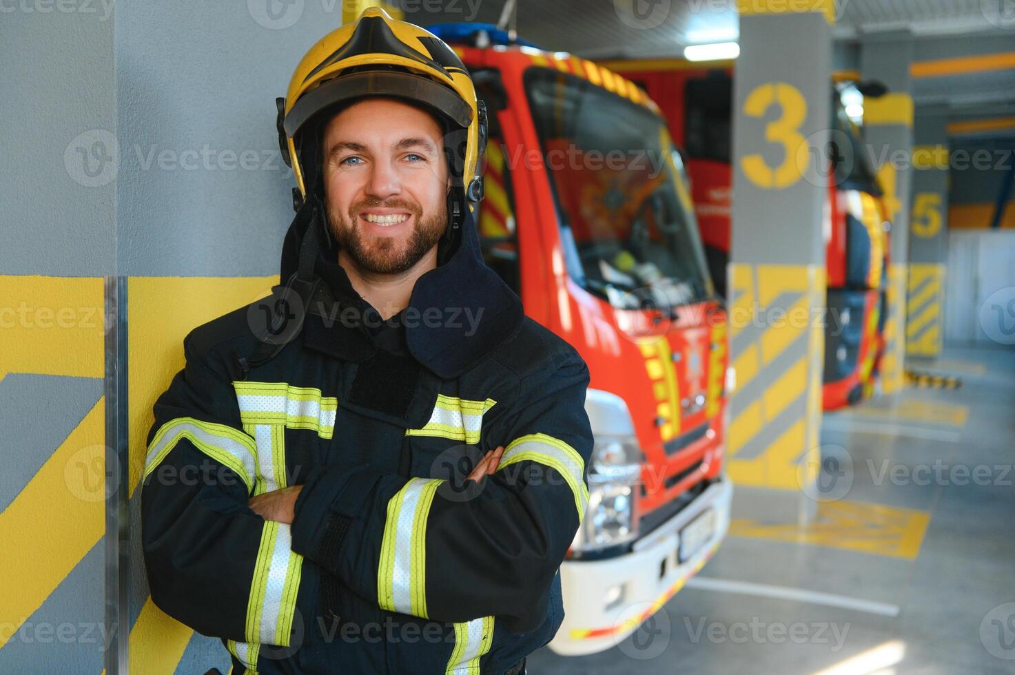 Portrait of male firefighter in uniform at fire station photo