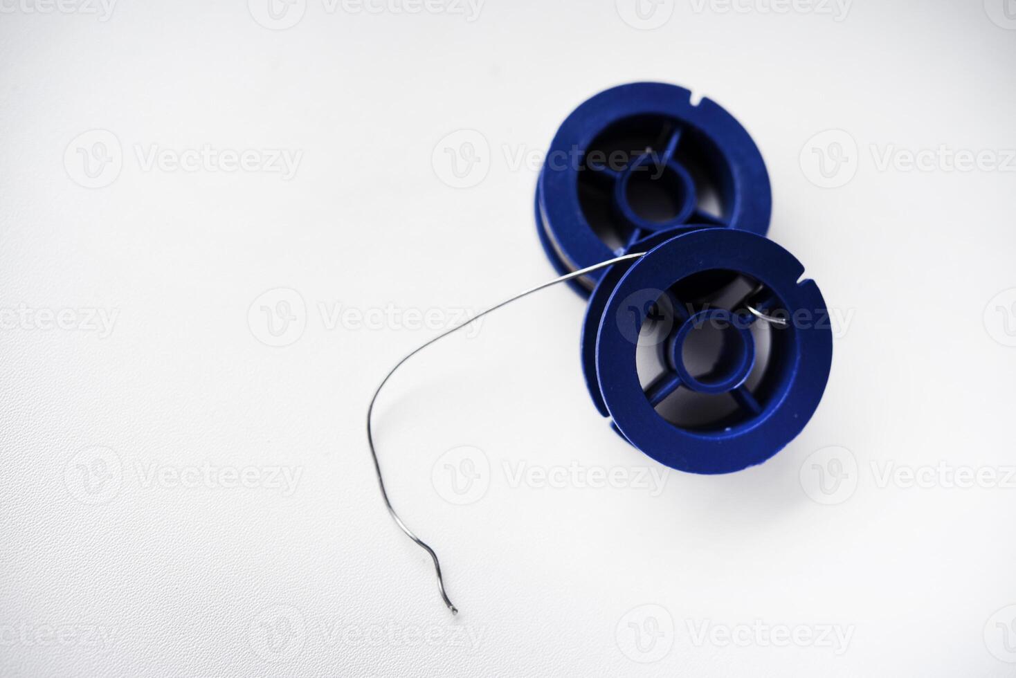 Tin-lead solder in coils on a white background. Materials for soldering. photo