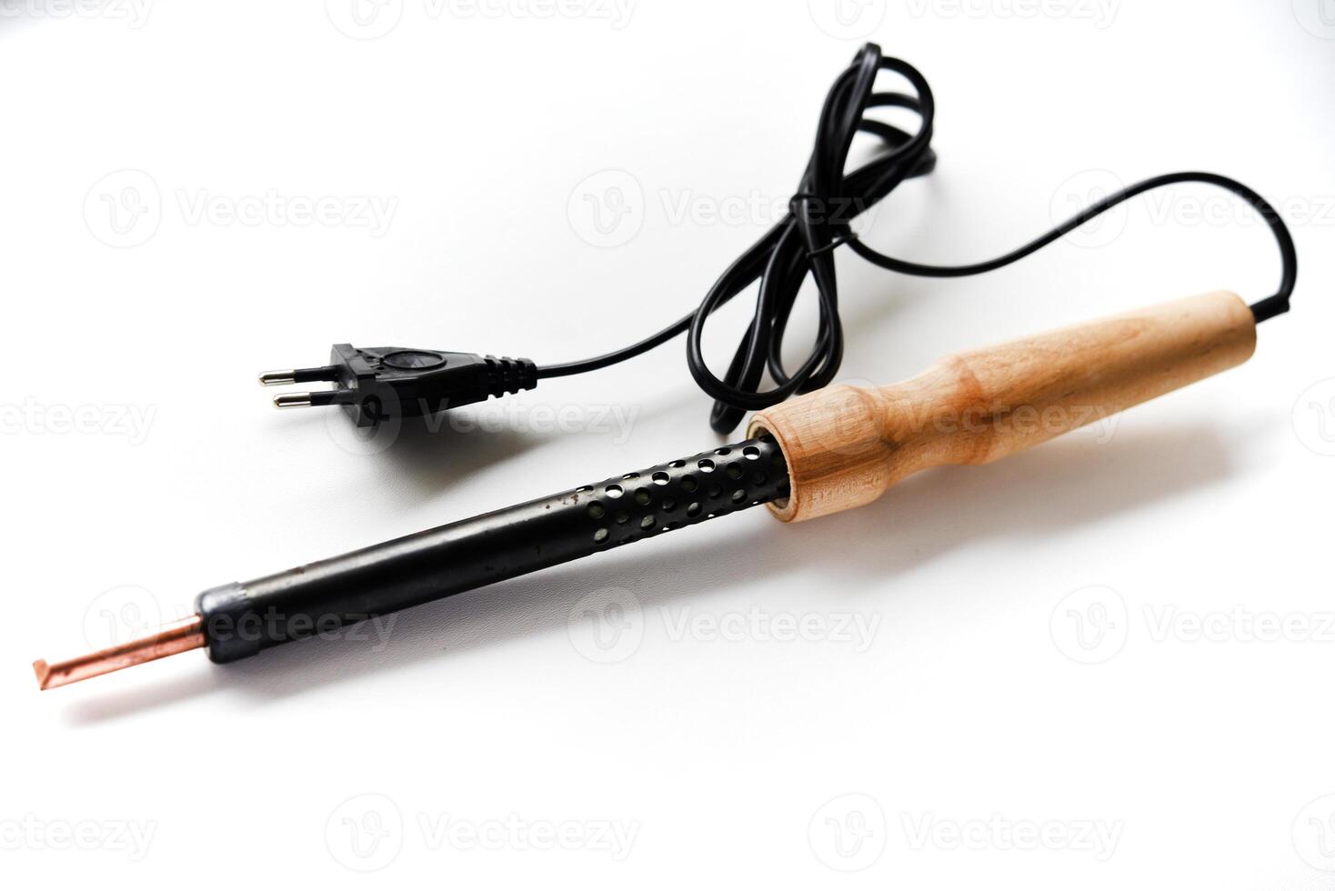 Electric soldering iron with a wooden handle on a white background. A tool for soldering radio components. photo