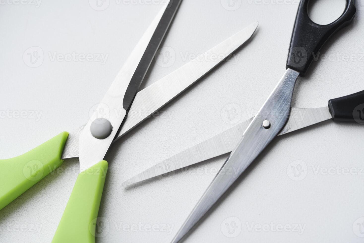 Sewing scissors on a white background. Green scissors. photo