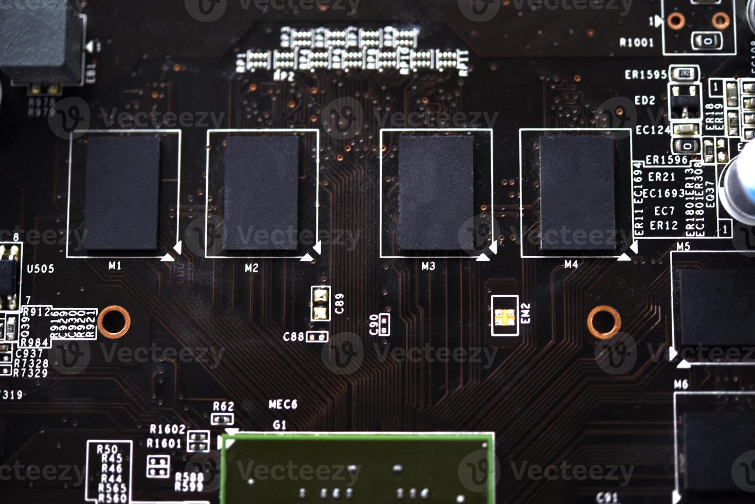 A brown printed circuit board with a processor chip and memory strips. Electronic components on the graphics card. photo