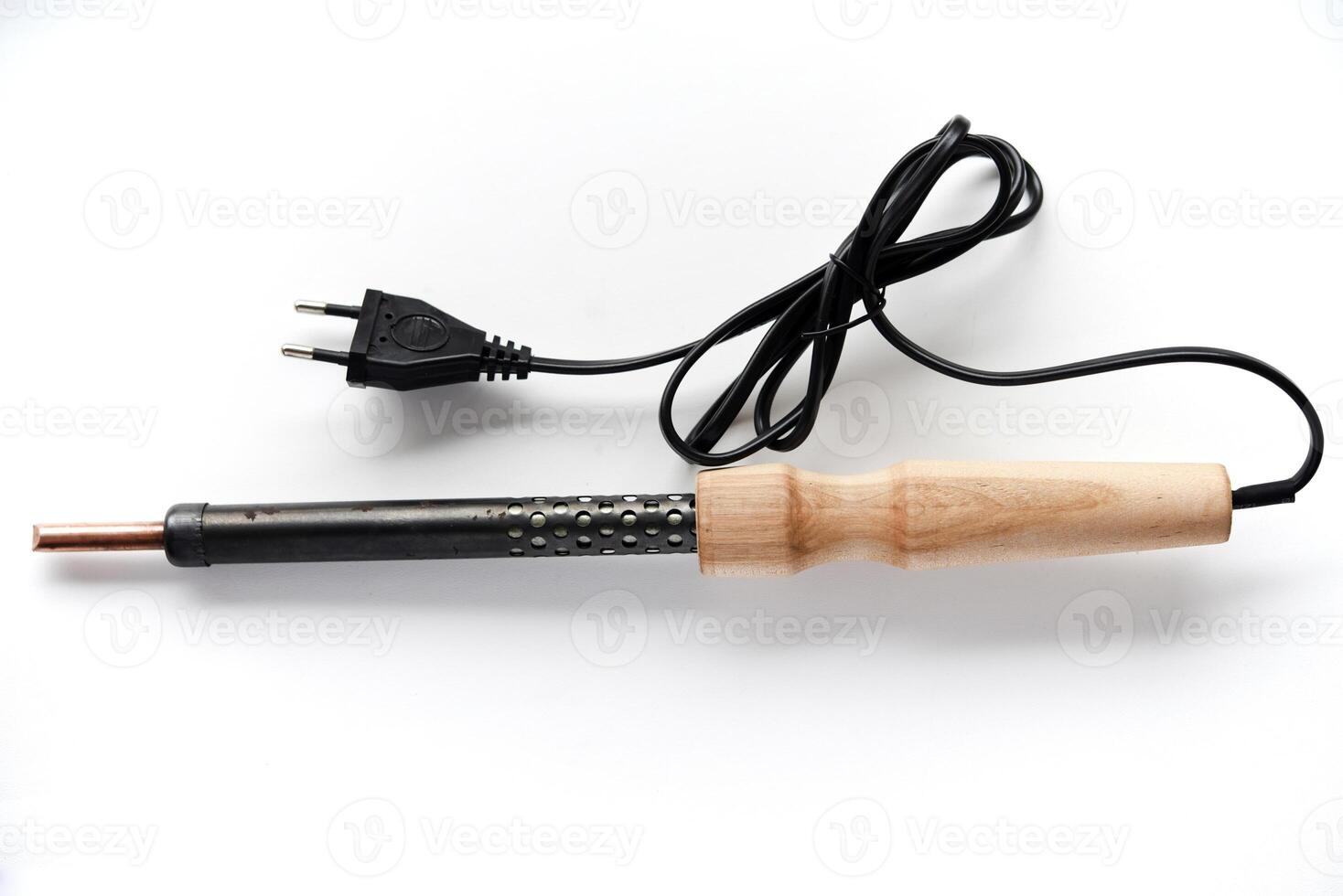 Electric soldering iron with a wooden handle on a white background. A tool for soldering radio components. photo