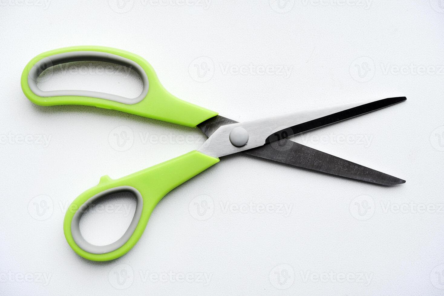 Sewing scissors on a white background. Green scissors. photo