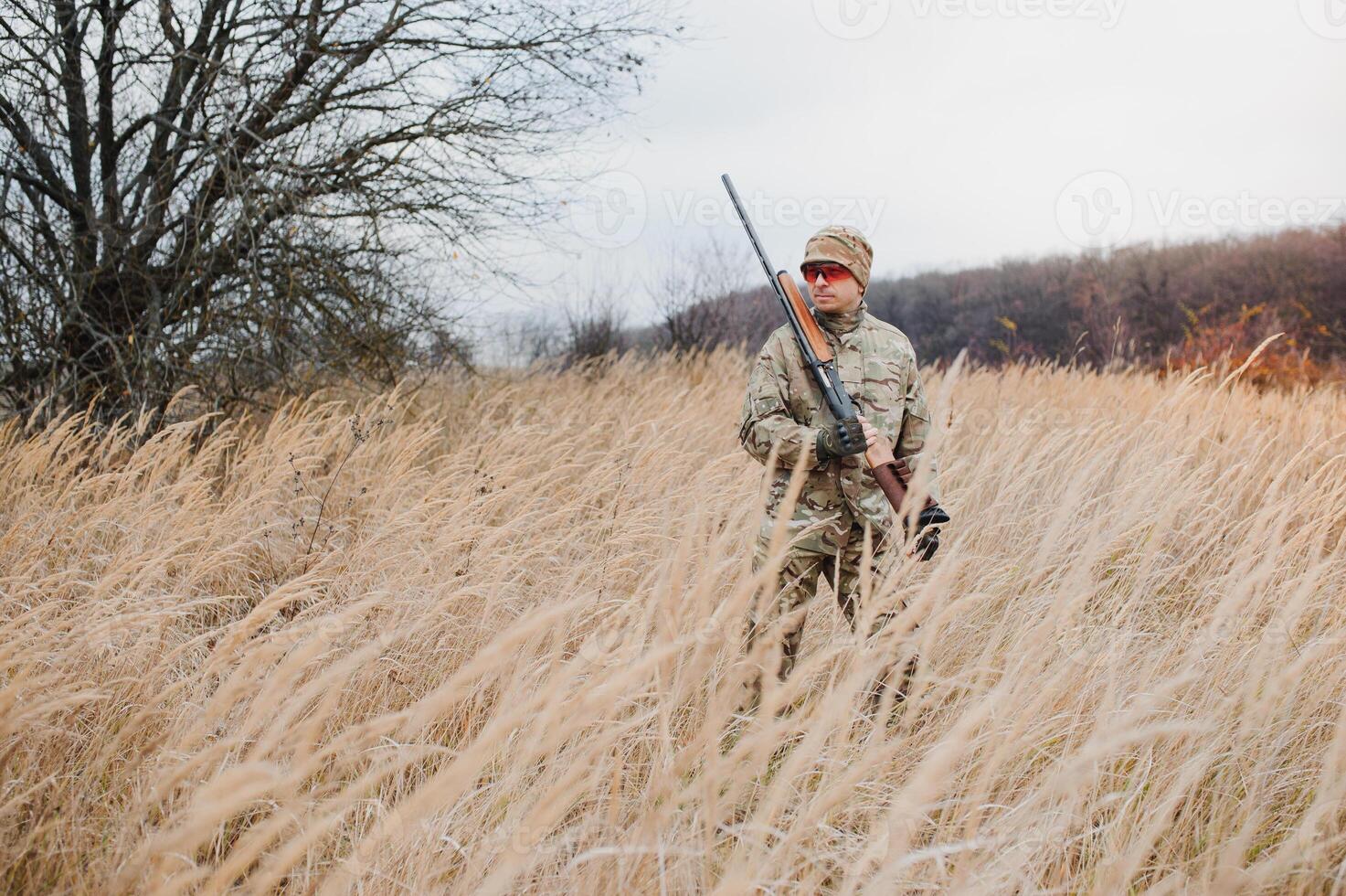 Hunter in uniform with a hunting rifle. Hunting Concept photo