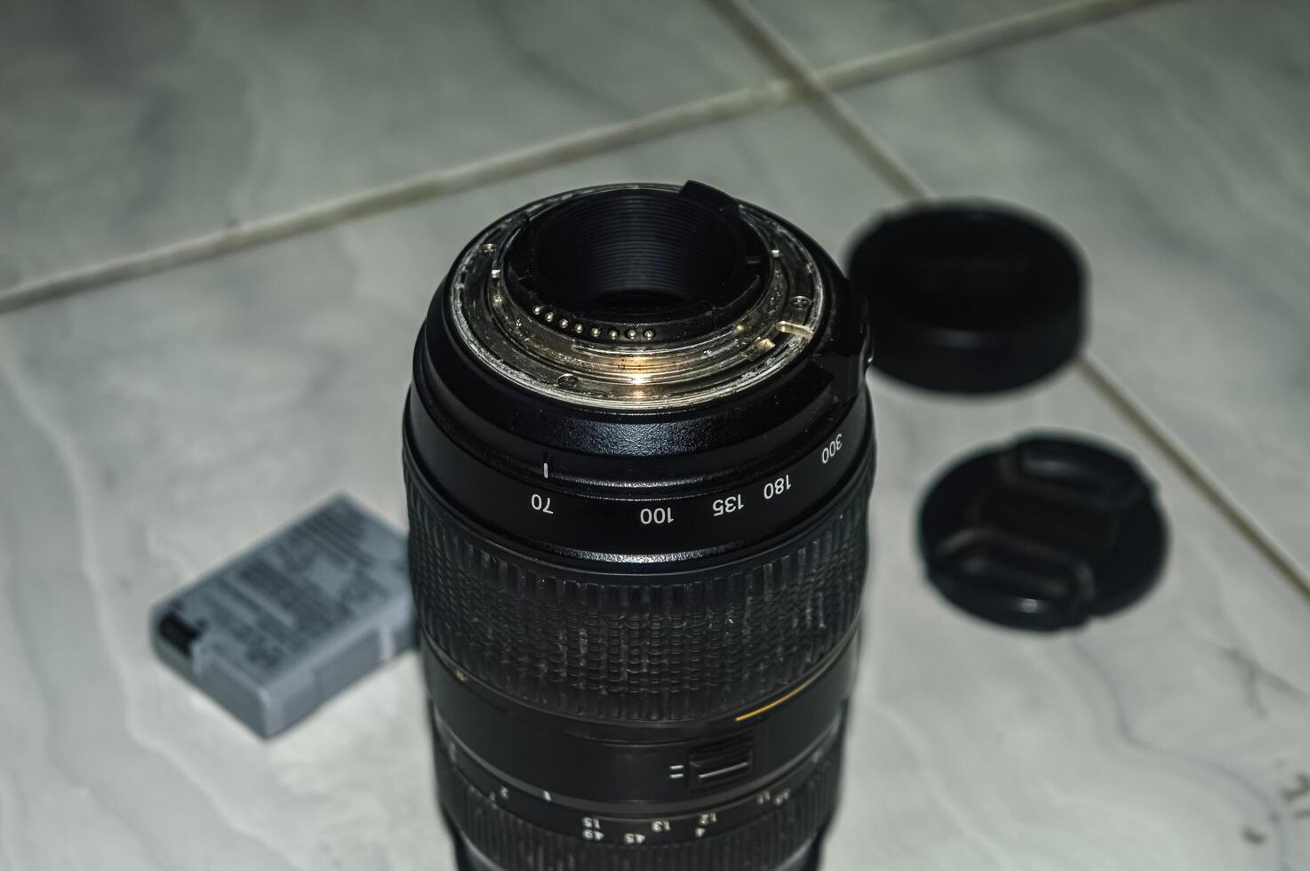 a black telephoto lens with camera equipment in the background. perfect for photography content. photo