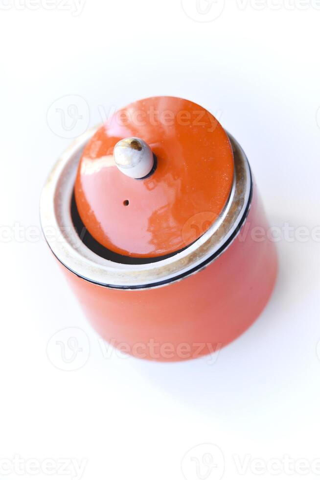 Red ceramic sugar bowl on a white background. Sugar in a jar. photo