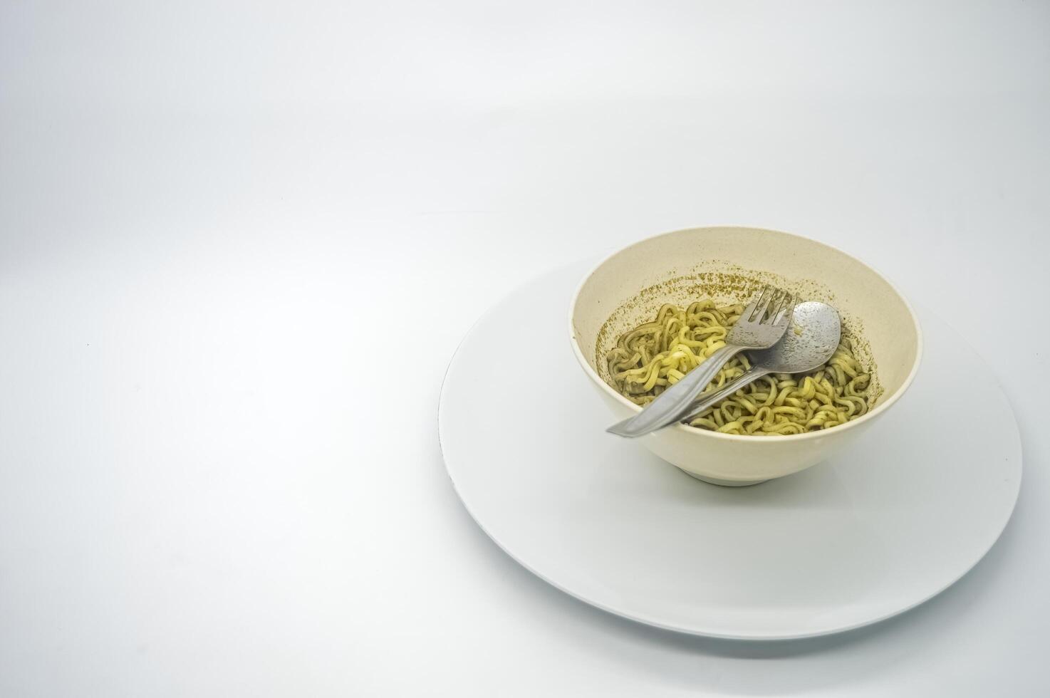 A bowl of instant noodles with rawon flavored soup served isolated on white background with copy space. perfect for menus, and cooking content. photo