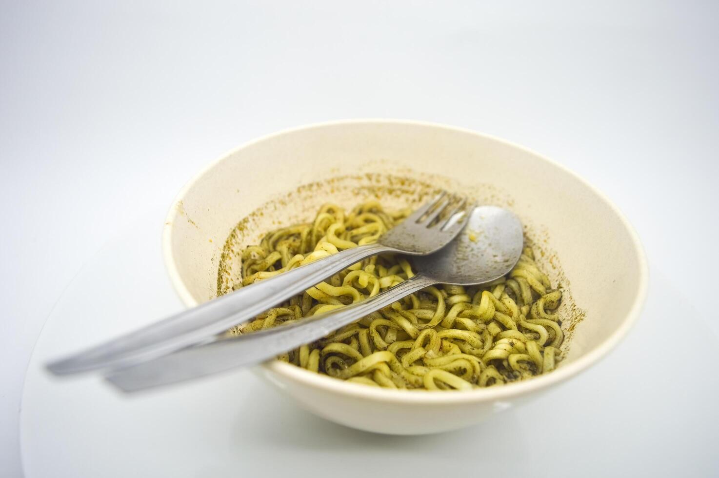A bowl of instant noodles with rawon flavored soup served isolated on white background with copy space. perfect for menus, and cooking content. photo
