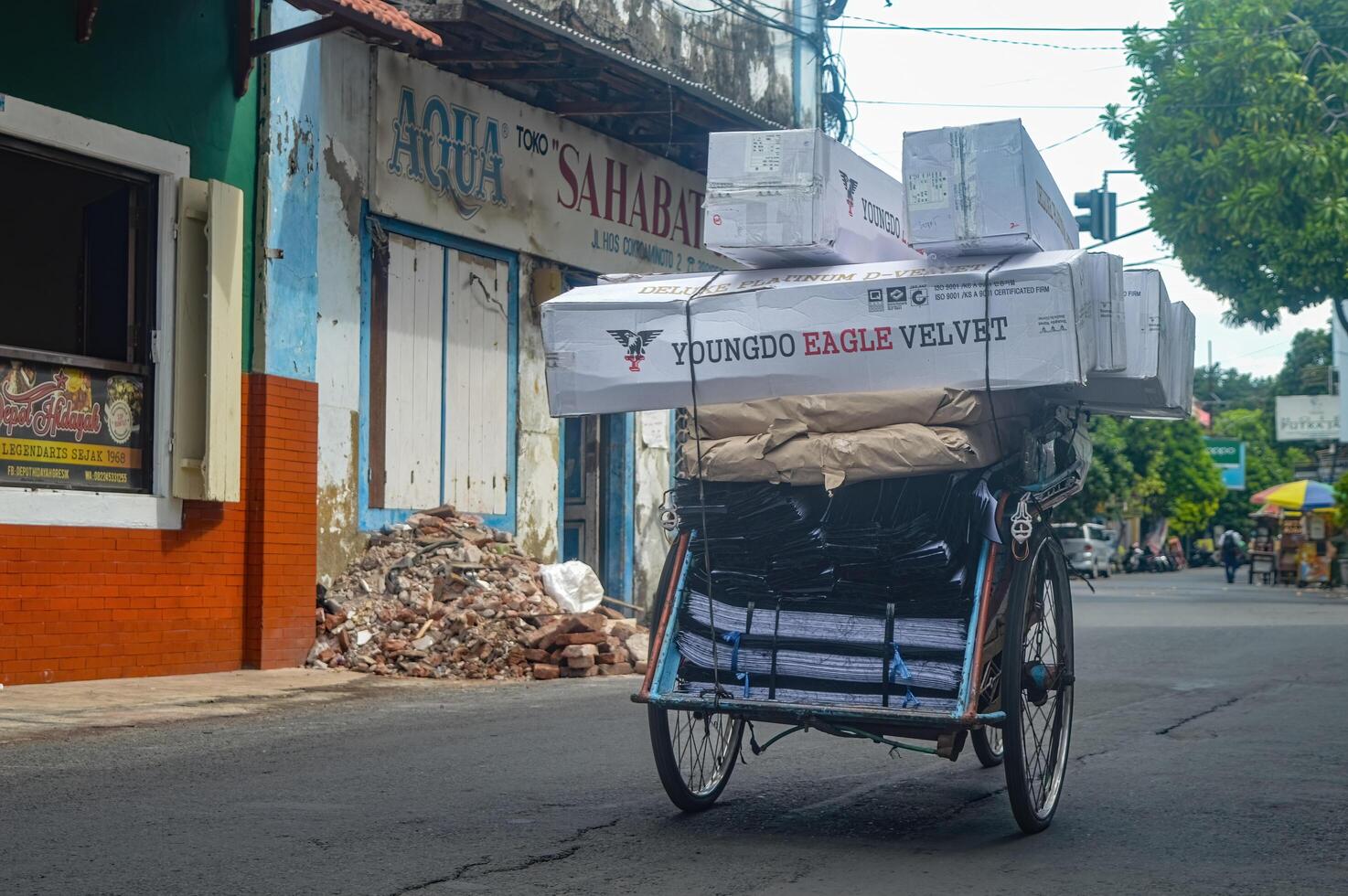 a rickshaw carrying quite a lot of cardboard goods photo