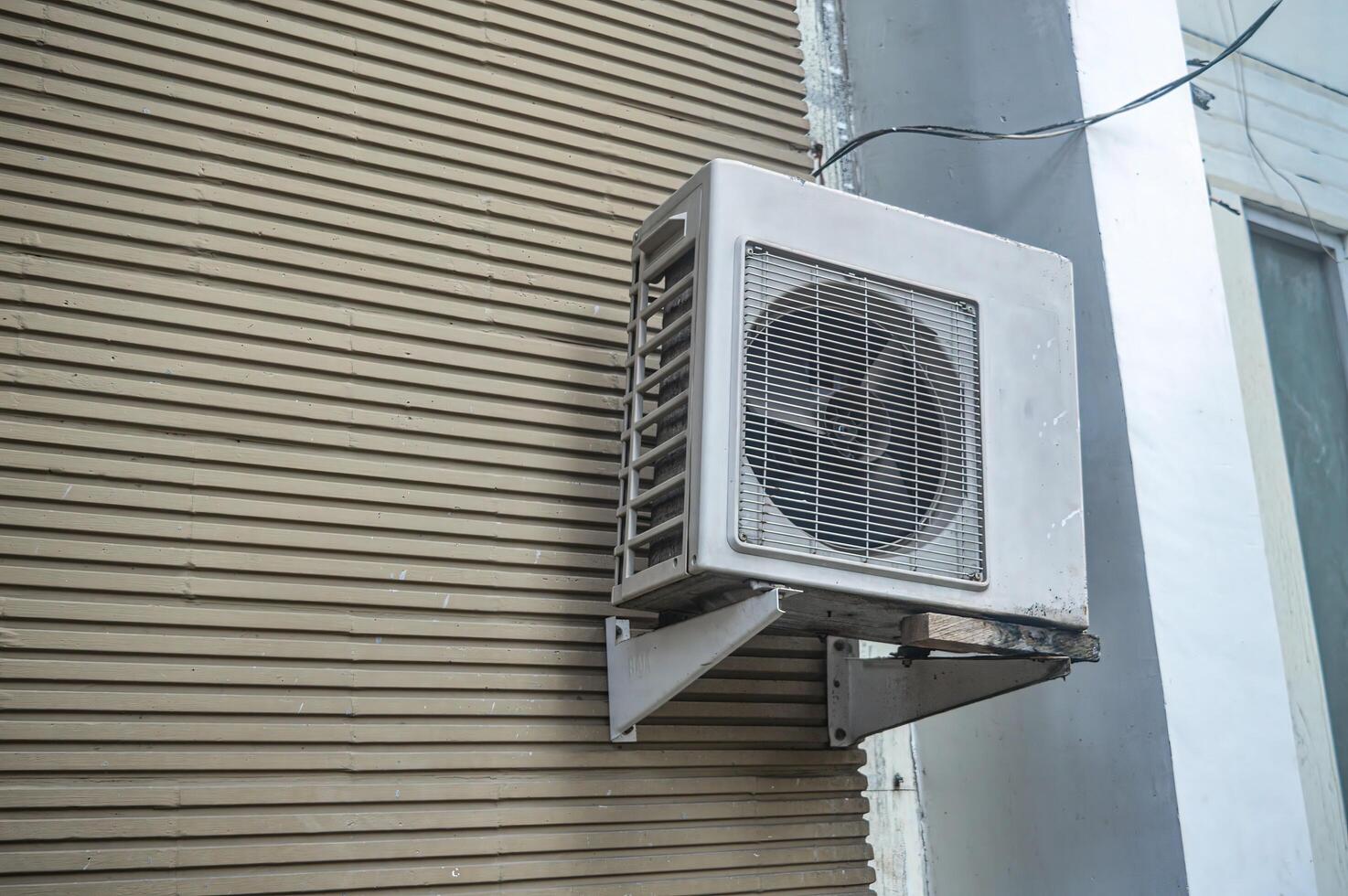 an air conditioner condenser attached to the wall photo