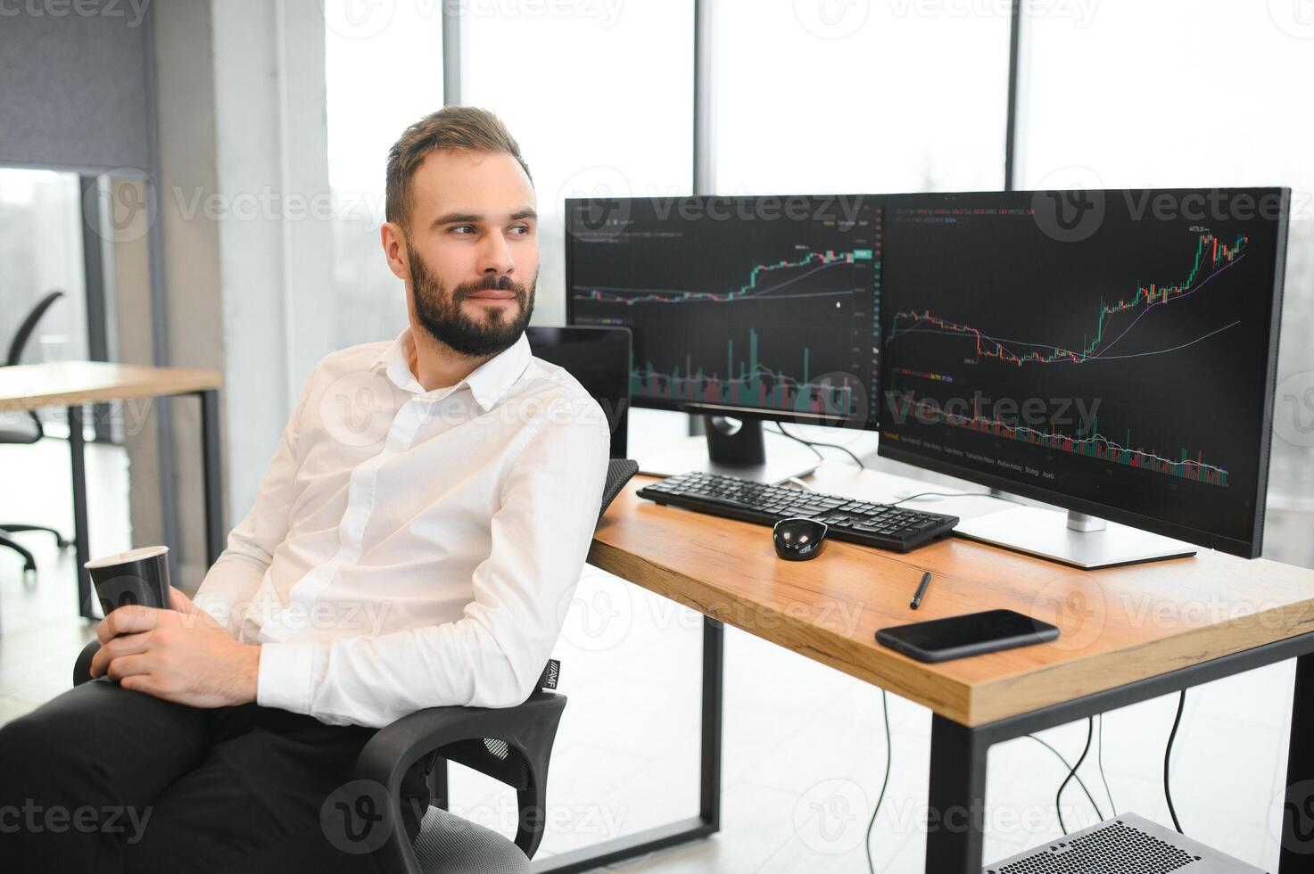 business man looking at the charts of the stock market of cryptocurrencies on the PC screen photo