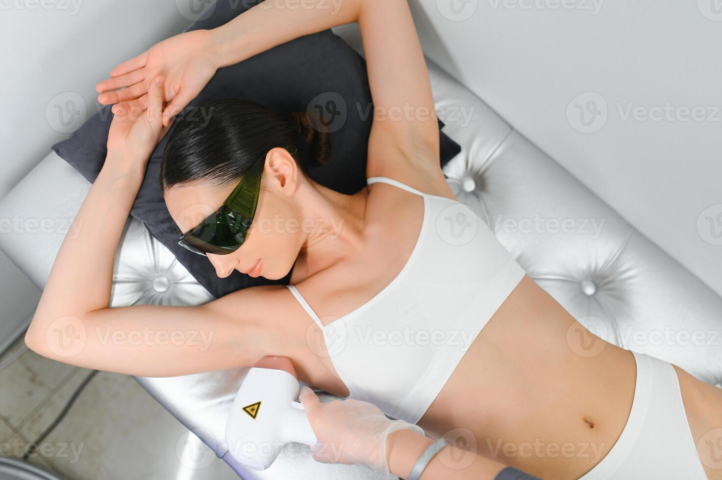 Woman getting laser treatment on her armpit in a beauty salon, close up photo