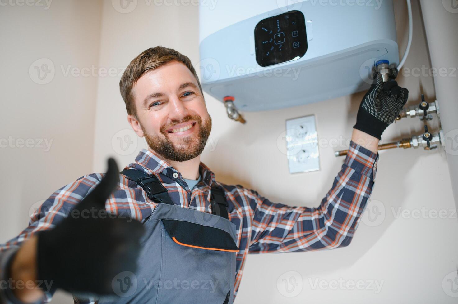 Professional plumber checking a boiler and pipes, boiler service concept photo