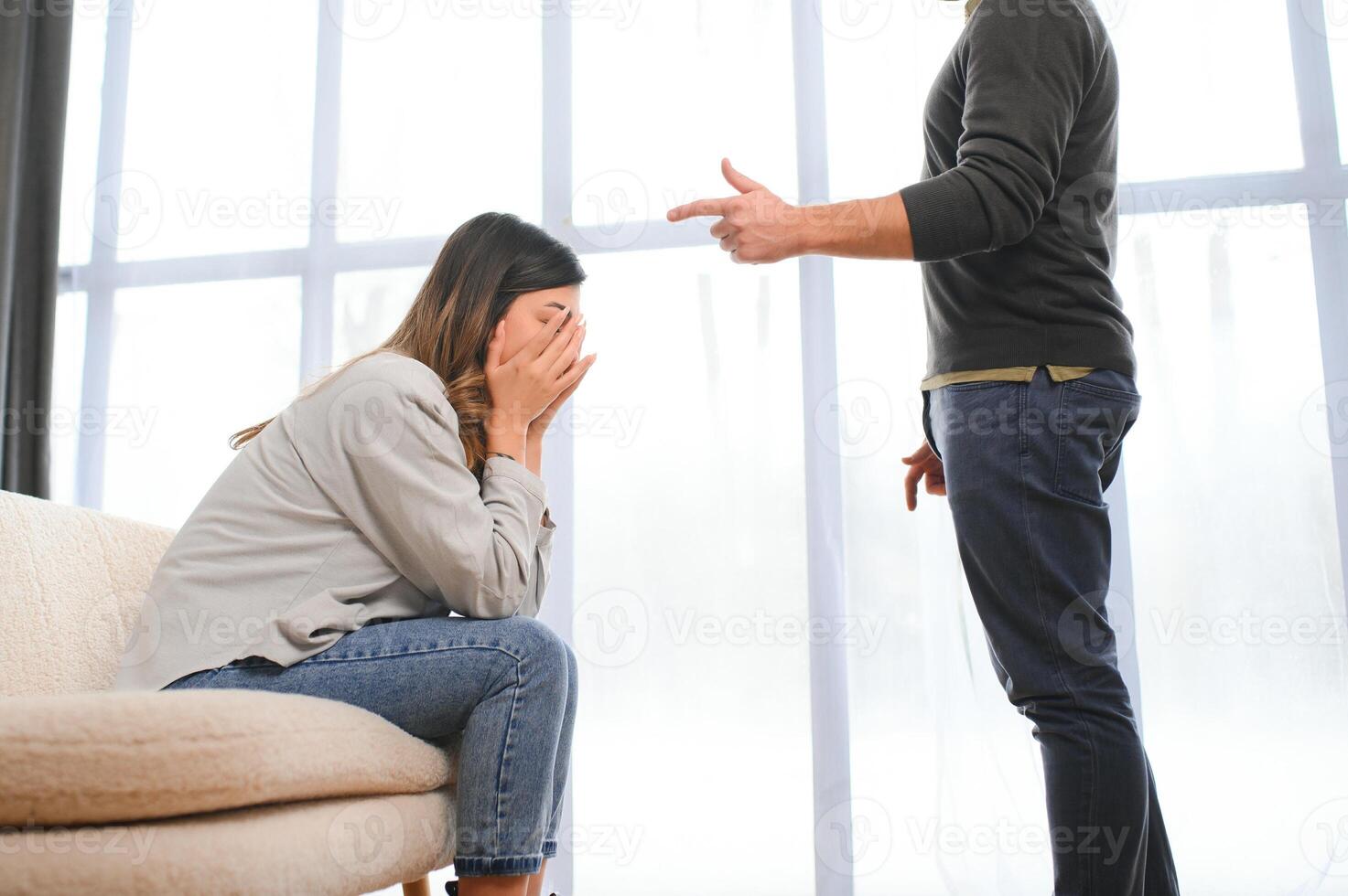 An agitated and upset husband shouts and looks at his wife, a quarrel between spouses. Family misunderstanding, quarrel photo