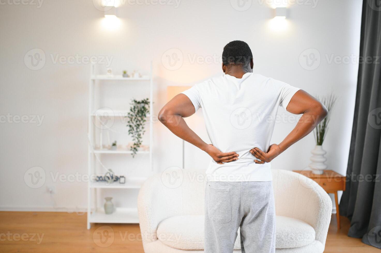 Young African Man Having Back Pain photo