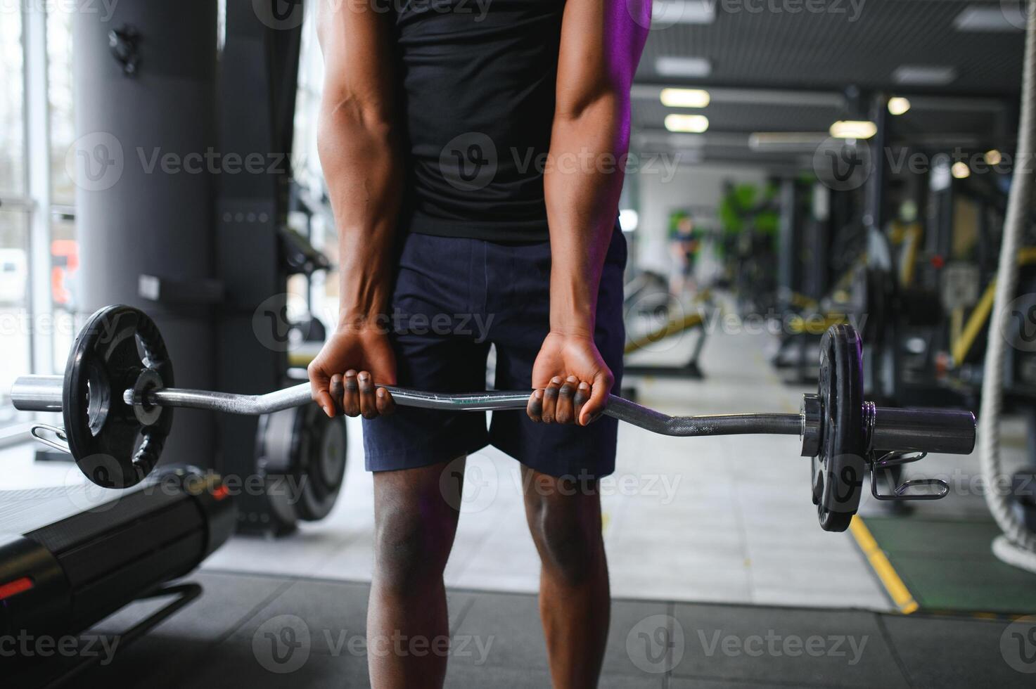 Athletic black guy making weightlifting or powerlifting at modern gym photo