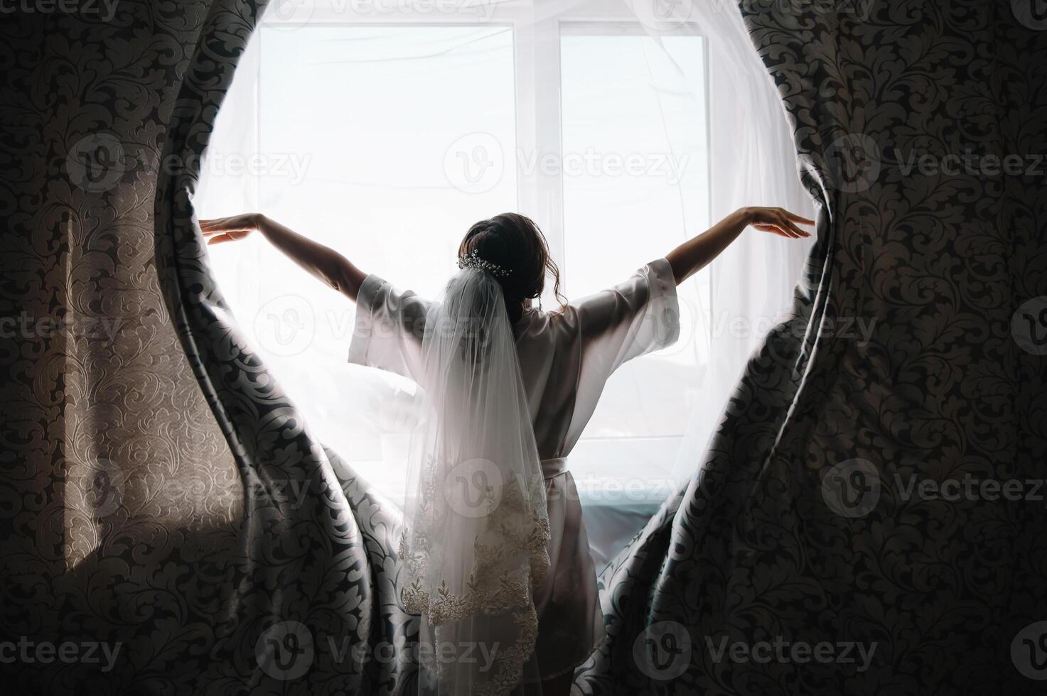 Bridesmaid preparing bride. Bridesmaid helps fasten a wedding dress the bride before the ceremony. Luxury bridal dress close up. Best wedding morning photo