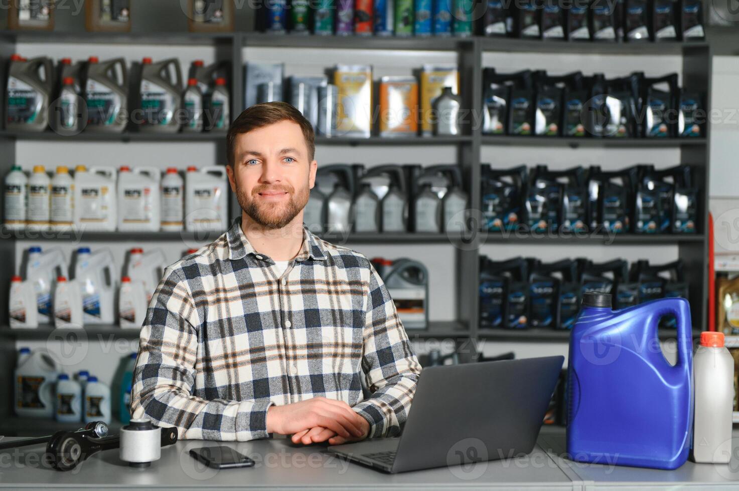 Portrait of a handsome salesman in an auto parts store. The concept of car repair photo