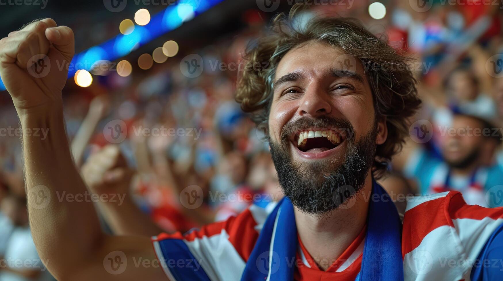 Ecstatic fan in stadium cheering with raised fist photo