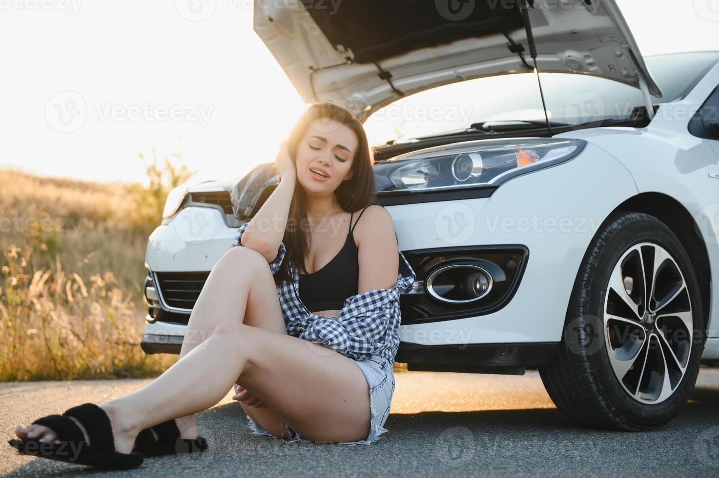 Sad woman depressed not knowing what to do with broken car photo