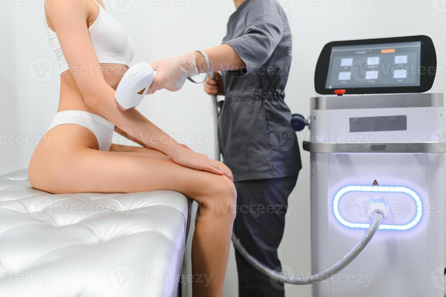 Close up Laser hair removal in the beauty salon. Woman having hands epilation. photo