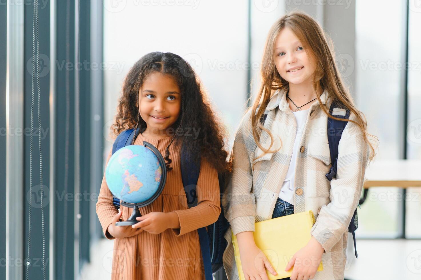 Portrait of happy multiracial elementary schoolgirls. school concept photo