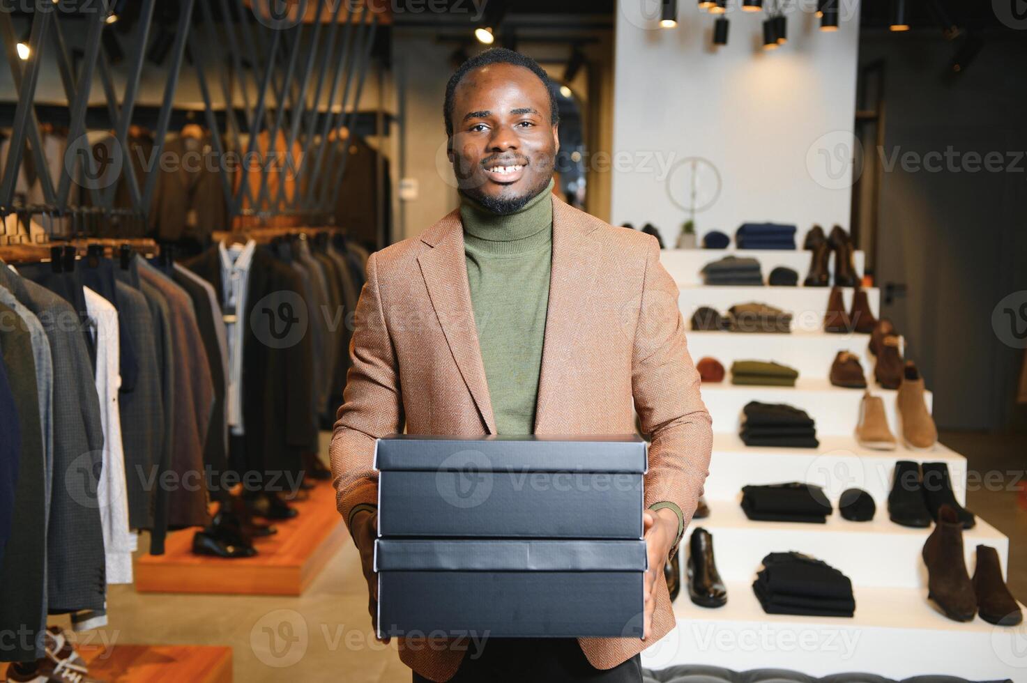 A handsome young african gentleman buying an elegant suit photo