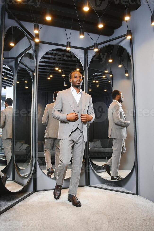 Young african man shopping in clothing store photo