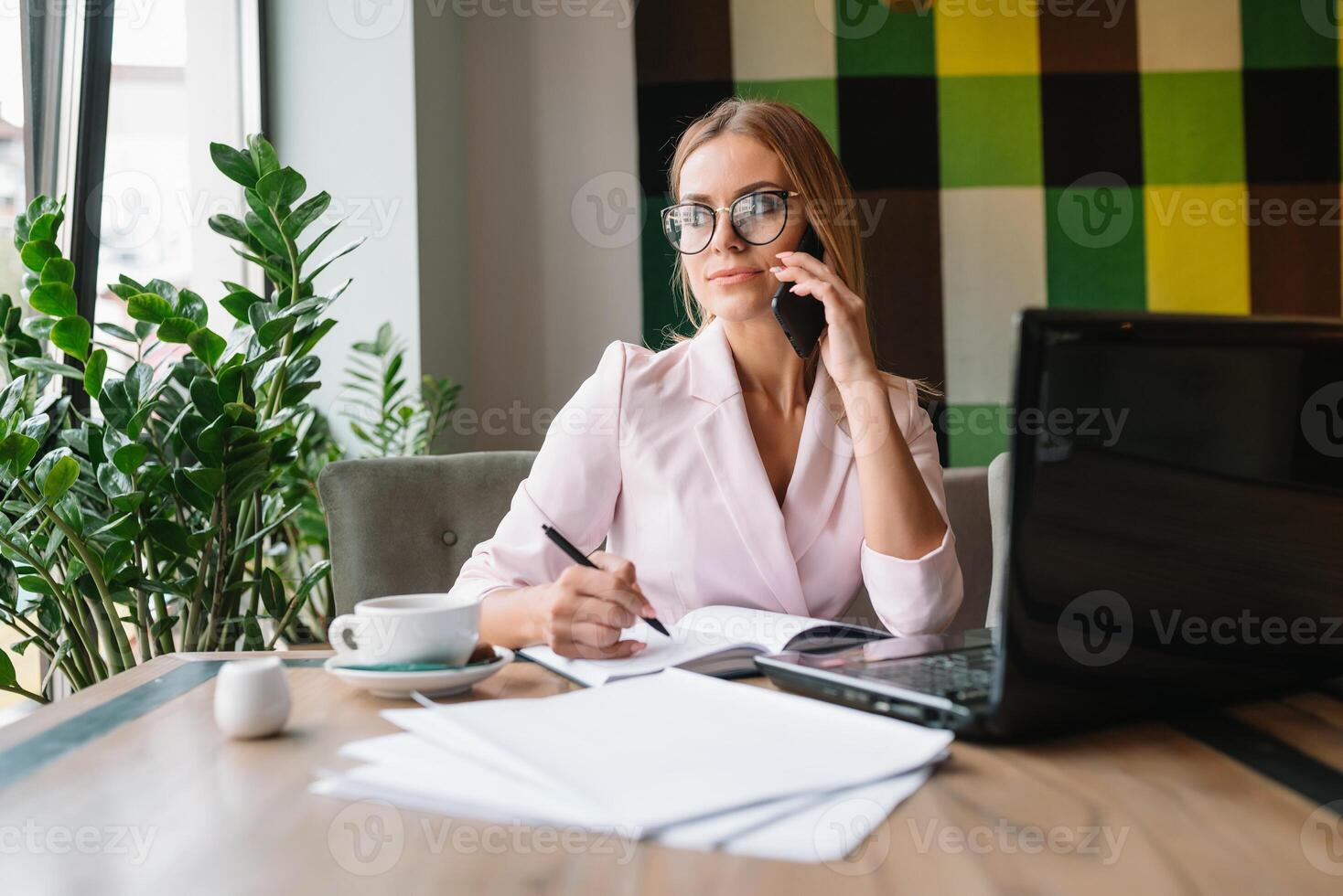 beautiful business lady drinking coffee and uses different gadgets photo